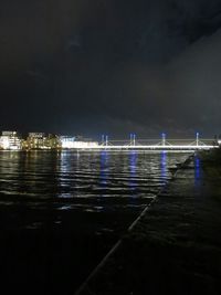 View of illuminated sea at night