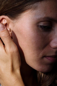 Close up of a woman ear with multiple earrings