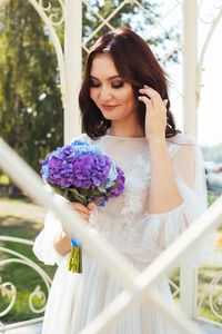 Close-up of happy woman holding white flower