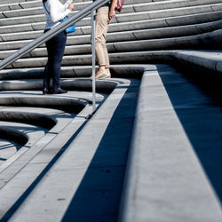 Low section of women standing on staircase