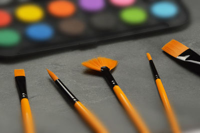 Close-up of various paintbrush on table