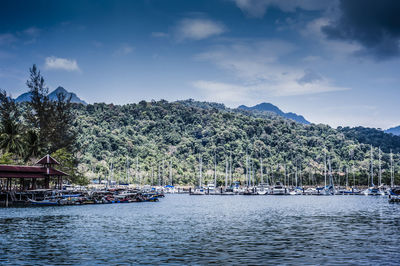 Scenic view of river and mountains against cloudy sky