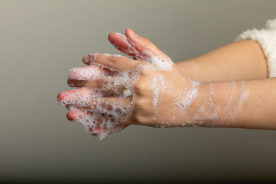 Close-up of person hand on wet floor
