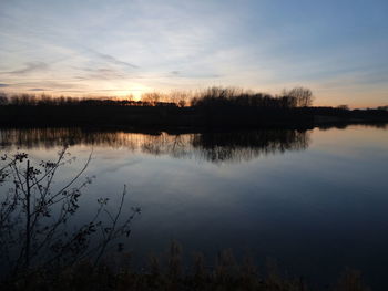 Scenic view of lake against sky during sunset