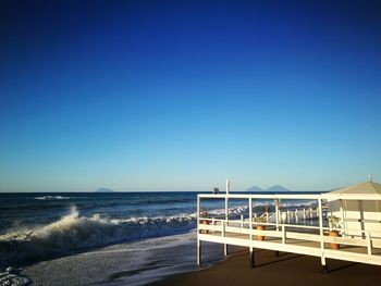 Scenic view of sea against clear blue sky