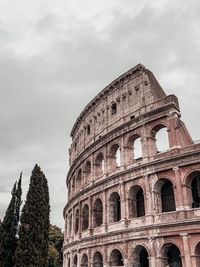 Low angle view of coliseum against sky