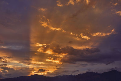 Low angle view of dramatic sky during sunset