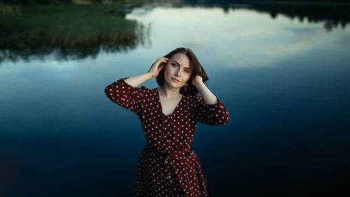 Portrait of a beautiful young woman standing in water