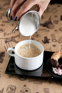 Close-up of hand holding coffee cup