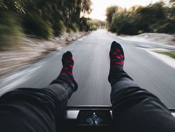 Low section of person standing on road