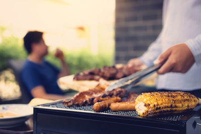 Man preparing food on barbecue grill