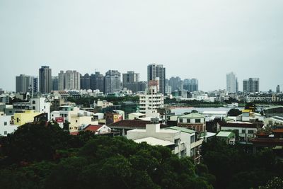 High angle view of buildings in city against clear sky