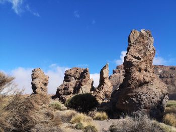 Low angle view of rock formations against sky