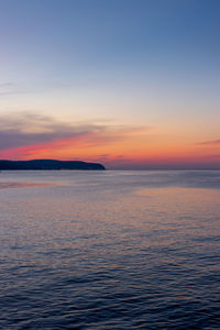 Scenic view of sea against romantic sky at sunset
