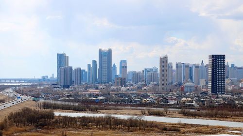 Modern buildings in city against sky