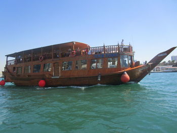 Ship moored on sea against clear sky