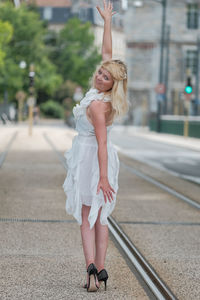 Full length of woman standing on railroad track