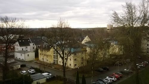 High angle view of houses in town against sky