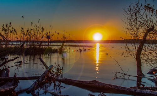 Scenic view of lake against sky during sunset