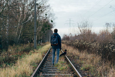 Man walking on railroad track