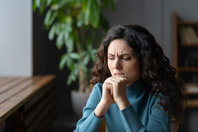 Upset thoughtful woman thinking about bad news scared anxious, suffer from problem at work, anxiety