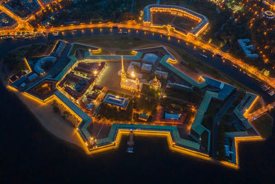 High angle view of illuminated city street and buildings at night