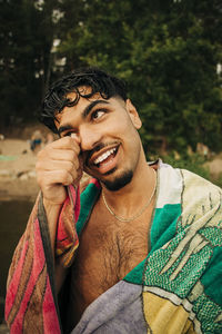 Smiling man looking away wearing towel