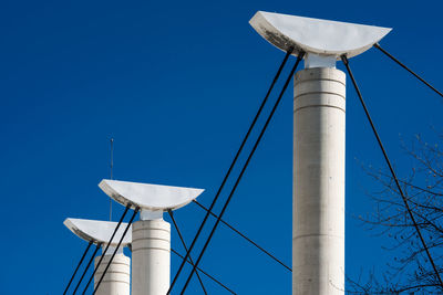 Low angle view of windmill against clear blue sky