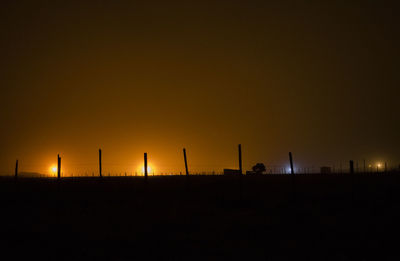 Silhouette of factory at sunset