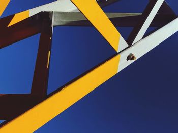 Low angle view of yellow structure against blue sky