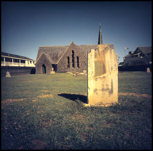 Historic building on field against clear sky