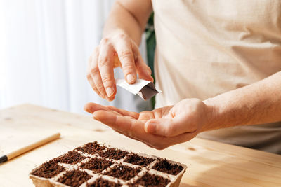 Midsection of man working on table