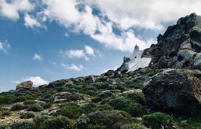 Low angle view of rocks on mountain against sky