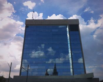 Low angle view of building against cloudy sky