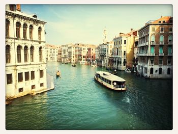 Boats in canal with buildings in background