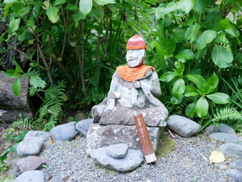 Statue against stone wall
