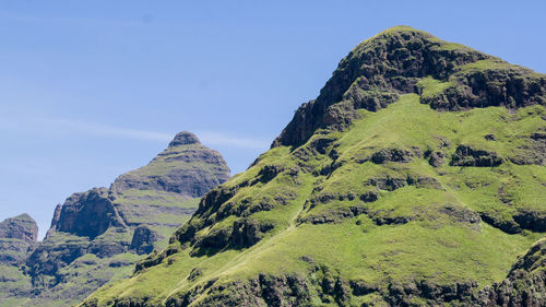 Panoramic view of mountain range against blue sky