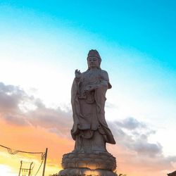 Low angle view of statue against sky during sunset