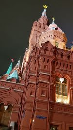 Low angle view of illuminated building against sky