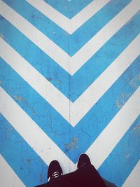 Low section of person standing on painted floor