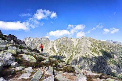 Low angle view of man standing on mountain