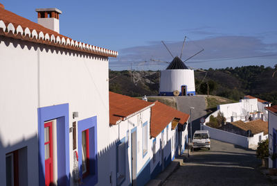Colourful houses and street with windmill in rural portugal