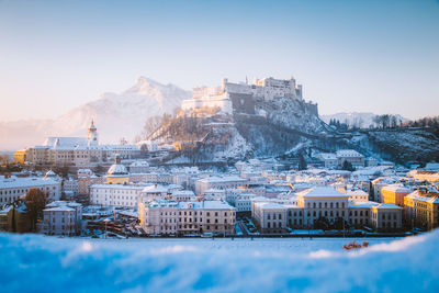 Snowcapped townscape against clear sky