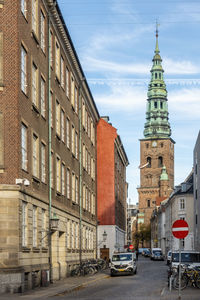 Cars on street amidst vintage buildings in city