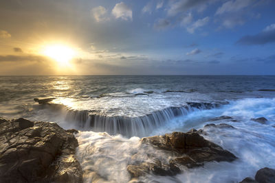 Scenic view of sea against sky during sunset