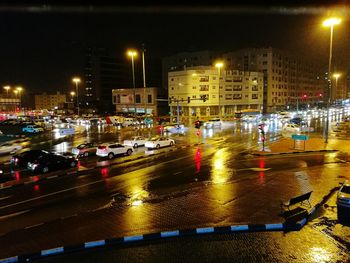 Cars on road against sky in city at night