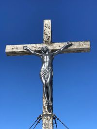 Low angle view of statue against blue sky