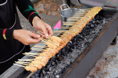 Man preparing food on barbecue grill