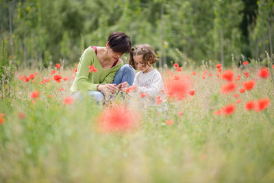 Mother and daughter in grassy field