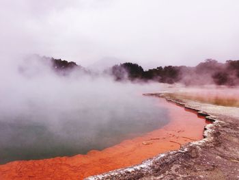 Scenic view of geyser against sky